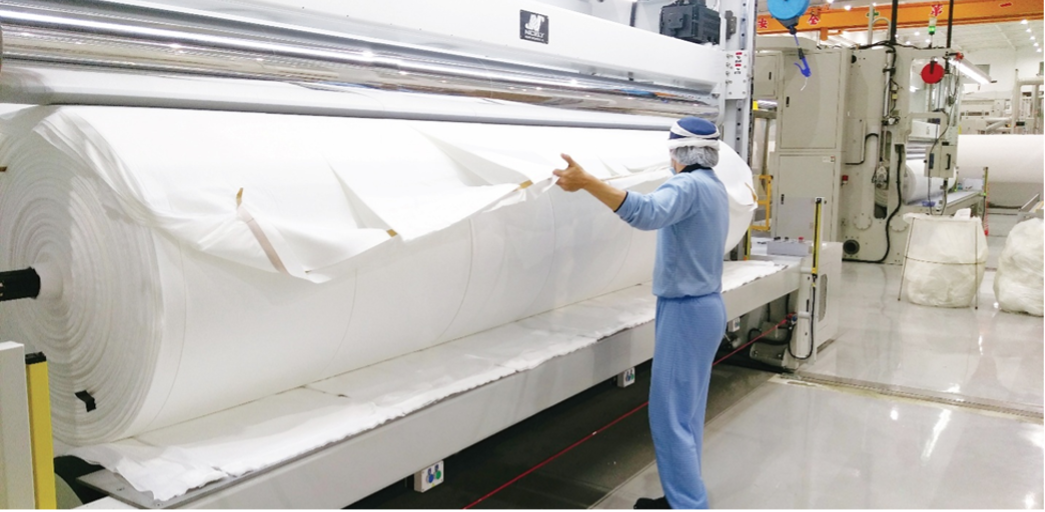 Professional operator managing a hot air nonwoven production line, addressing the skills gap in soft web handling.