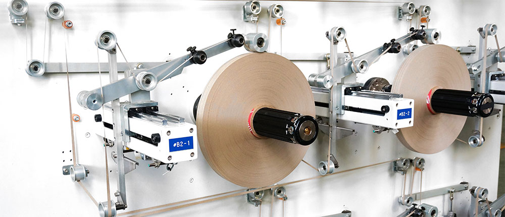 EG-9000 spooling slitter rewinder — multiple spool heads with individual tension control for mica tape and aramid paper.