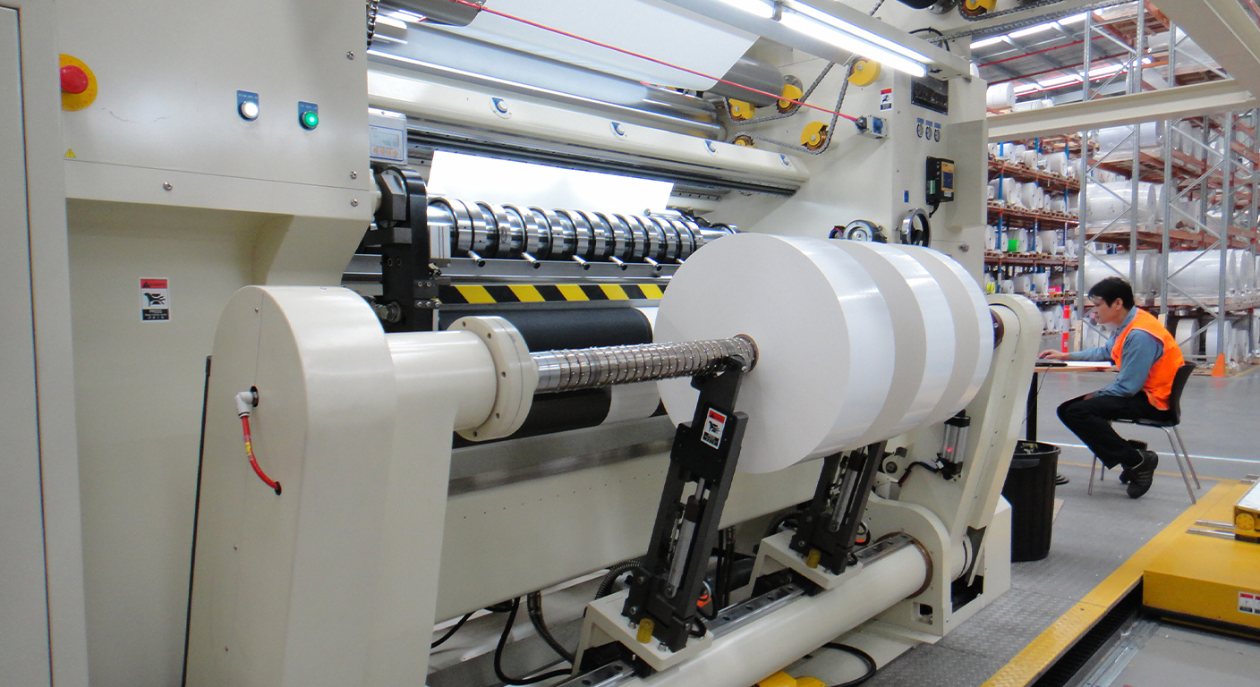 Release liner master roll and slit reels on slitter rewinder